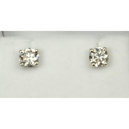 5A - A PAIR OF 18CT WHITE GOLD FOUR CLAW ROUND BRILLIANT CUT DIAMOND SOLITAIRE EARRINGS. (Diamonds approx... 