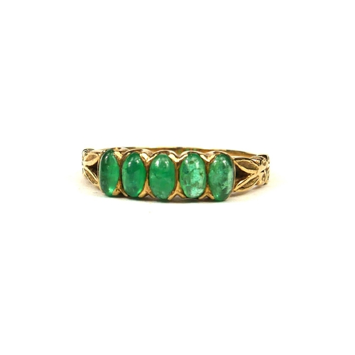 63 - A 9CT GOLD AND FIVE STONE NEPHRITE RING.
(size S)