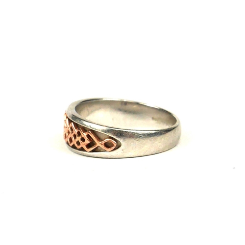 67 - A WELSH WHITE AND ROSE METAL RING.
(tested for silver and 9ct, UK size N, 3.9g)