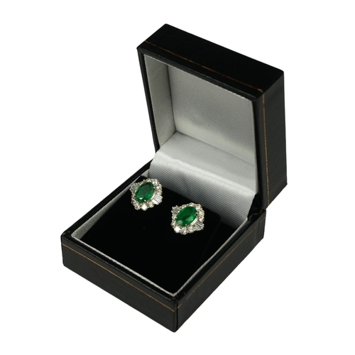 8A - A PAIR OF 18CT WHITE GOLD OVAL EMERALD AND DIAMOND CLUSTER STUD EARRINGS. (Approx Emeralds 2.05ct.  ... 