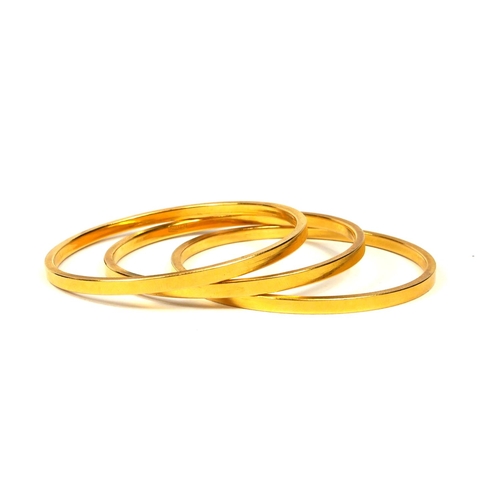 9 - THREE 21CT GOLD BANGLES
Having textured sides and polished interior and exterior finish. 
(diameter ... 