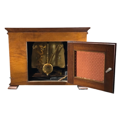 119 - ELLIOT, LONDON, AN ART DECO 8-DAY LEVER WESTMINSTER WALNUT AND EBONISED MANTLE CLOCK 
Having a silve... 