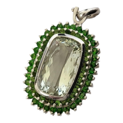 41A - A LARGE SILVER AND GREEN PRESULITE QUARTZ PENDANT
The rectangular faceted central stone with round c... 