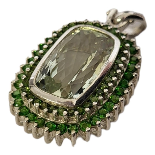 41A - A LARGE SILVER AND GREEN PRESULITE QUARTZ PENDANT
The rectangular faceted central stone with round c... 