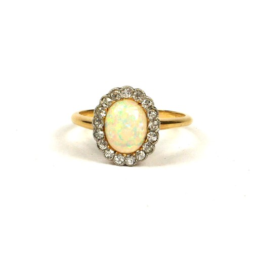 15A - AN 18CT YELLOW GOLD, OPAL AND 17 DIAMOND CLUSTER RING
Inside a Goldsmiths & Silversmiths, Regent Str... 