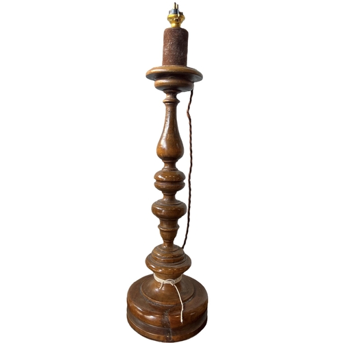 154 - THREE 18TH CENTURY ITALIAN WALNUT, GILTWOOD AND POLYCHROME CANDLESTICKS CONVERTED TO LAMPS.
(largest... 