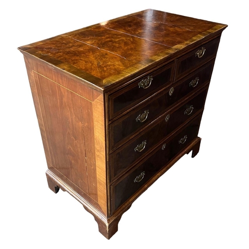 164A - AN 18TH CENTURY WALNUT AND HERRINGBONE INLAID CHEST OF DRAWERS
With quarter veneer top above two sho... 