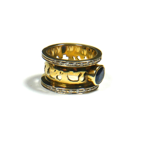 12 - A LARGE YELLOW METAL, SAPPHIRE AND DIAMOND RING, YELLOW METAL TESTED AS 18CT GOLD
Having pierced dec... 