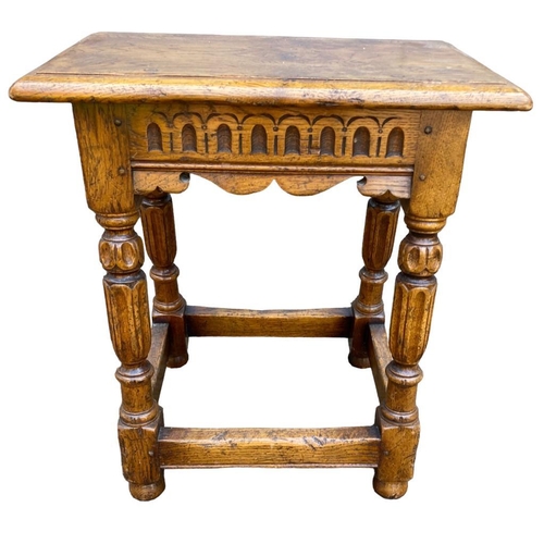 124 - A 17TH CENTURY DESIGN CARVED OAK JOINT STOOL.
(h 51cm x d 27cm x w 46.5cm)