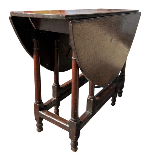 138 - A SMALL 17TH CENTURY WILLIAM AND MARY OAK GATELEG TABLE
The oval top support on eight turned gun bar... 