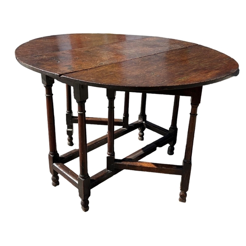 138 - A SMALL 17TH CENTURY WILLIAM AND MARY OAK GATELEG TABLE
The oval top support on eight turned gun bar... 