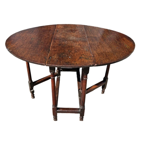 138 - A SMALL 17TH CENTURY WILLIAM AND MARY OAK GATELEG TABLE
The oval top support on eight turned gun bar... 