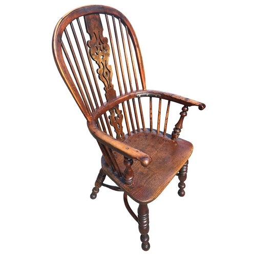 140 - A 19TH CENTURY YEW WOOD AND ELM WINDSOR CHAIR
The pierced splat and turned spindles above a solid sh... 