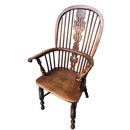 140 - A 19TH CENTURY YEW WOOD AND ELM WINDSOR CHAIR
The pierced splat and turned spindles above a solid sh... 