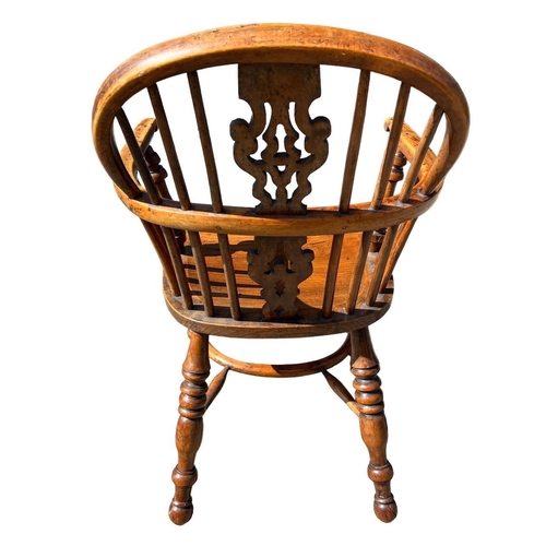 142 - A 19TH CENTURY YEW WOOD AND ELM WINDSOR CHAIR
The pierced splat and turned spindles above solid shap... 