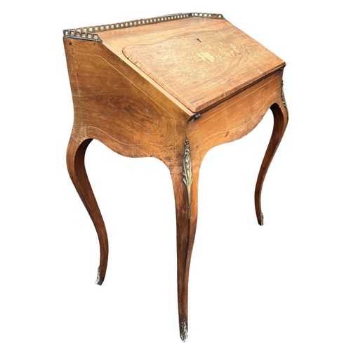 149 - A 19TH CENTURY GILT METAL MOUNTED ROSEWOOD AND MARQUETRY LADIES’ WRITING BUREAU
With gallery top abo... 