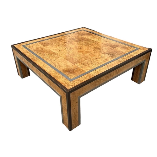 125 - MANNER OF PAUL EVANS, A 20TH CENTURY BURR WOOD AND METAL MOUNTED COFFEE TABLE.
H37.5 x W100.5 x D100... 