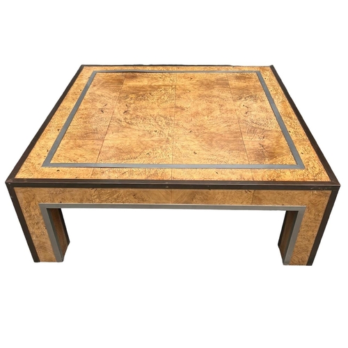 125 - MANNER OF PAUL EVANS, A 20TH CENTURY BURR WOOD AND METAL MOUNTED COFFEE TABLE.
H37.5 x W100.5 x D100... 