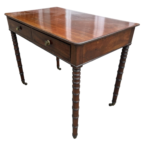 127 - MANNER OF GILLOWS, A 19TH CENTURY REGENCY MAHOGANY TWO DRAWER WRITING TABLE
With brass handles, rais... 