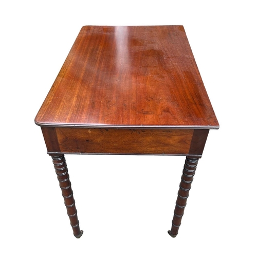 127 - MANNER OF GILLOWS, A 19TH CENTURY REGENCY MAHOGANY TWO DRAWER WRITING TABLE
With brass handles, rais... 