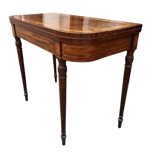 135 - MANNER OF GILLOWS, AN EARLY 19TH CENTURY MAHOGANY AND INLAID CARD TABLE 
Raised on carved and turned... 