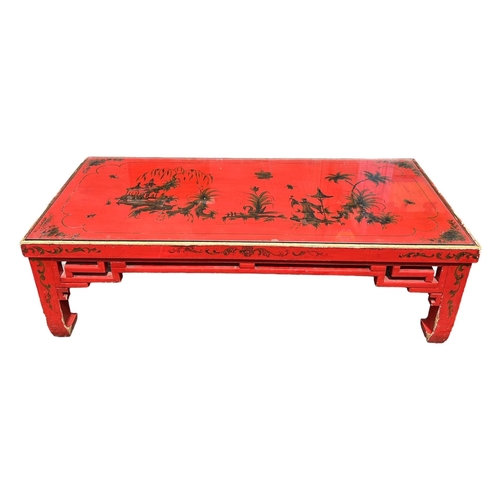 145 - A 20TH CENTURY RED LACQUERED CHINESE CHINOISERIE DECORATED LOW COFFEE TABLE.