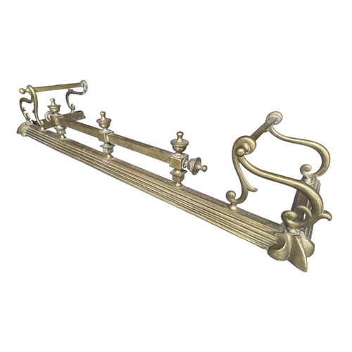 154 - A 19TH CENTURY VICTORIAN BRASS FIRE CURB
With scrolling decoration and urn finials.
(h 23cm x 38cm x... 