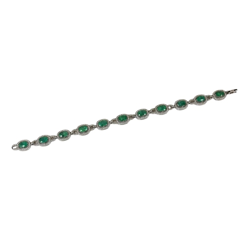 21 - AN 18CT WHITE GOLD, EMERALD AND DIAMOND LINE BRACELET, boxed.
(Approx oval emeralds 7.12ct total, Di... 