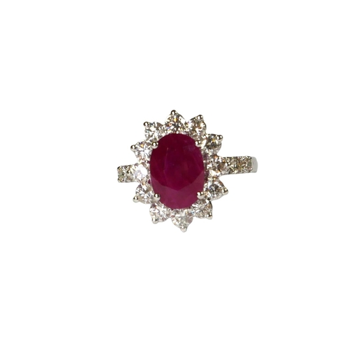 31 - AN 18CT WHITE GOLD, OVAL RUBY AND DIAMOND CLUSTER RING,
flanked by diamond shoulders, with WGI certi... 