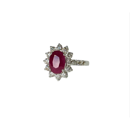 31 - AN 18CT WHITE GOLD, OVAL RUBY AND DIAMOND CLUSTER RING,
flanked by diamond shoulders, with WGI certi... 