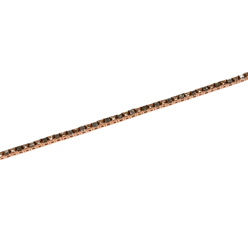 33 - A 10CT ROSE GOLD DIAMOND LINE BRACELET,
set with baguette cut and round brilliant cut diamonds, boxe... 