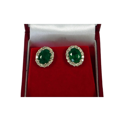 37 - AN 18CT WHITE GOLD, OVAL EMERALD AND DIAMOND CLUSTER STUDS, boxed.  
(Approx Emeralds 2.76ct, Diamon... 