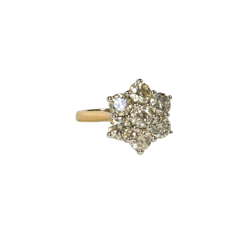 41 - AN 18CT WHITE AND YELLOW GOLD, DIAMOND SEVEN STONE DAISY STYLE CLUSTER RING,
with WGI Certificate.
(... 