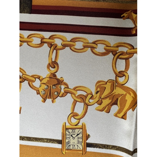 102A - DE MUST CARTIER, PARIS, A VINTAGE SILK SCARF
Decorated with charm bracelet and doorway motif, along ... 