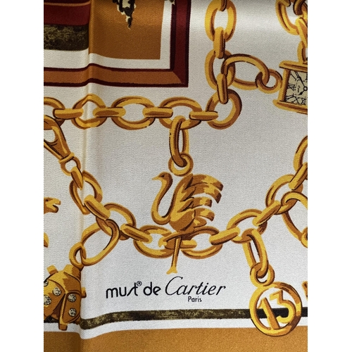 102A - DE MUST CARTIER, PARIS, A VINTAGE SILK SCARF
Decorated with charm bracelet and doorway motif, along ... 