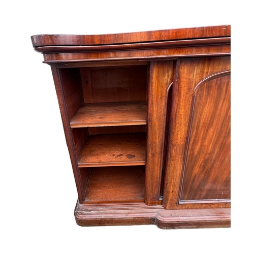 137 - AN UNUSUAL 19TH CENTURY FLAME MAHOGANY SERPENTINE SIDEBOARD 
With scrolling back above three sliding... 