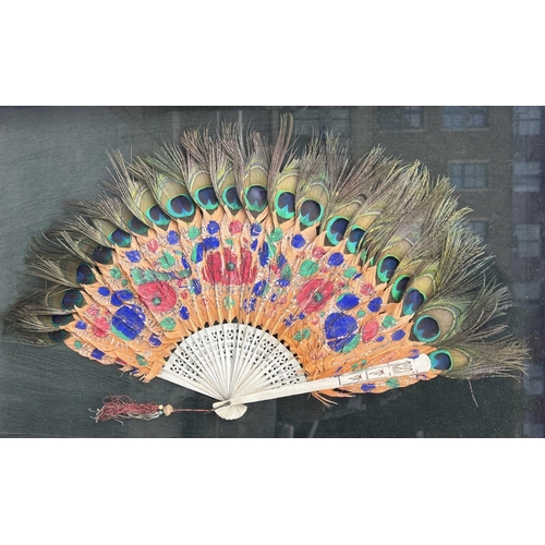 79 - A LARGE FRAMED 19TH CENTURY CHINESE CARVED BONE AND PEACOCK FEATHER FAN, HAVING TWO CIRCULAR JADE BE... 