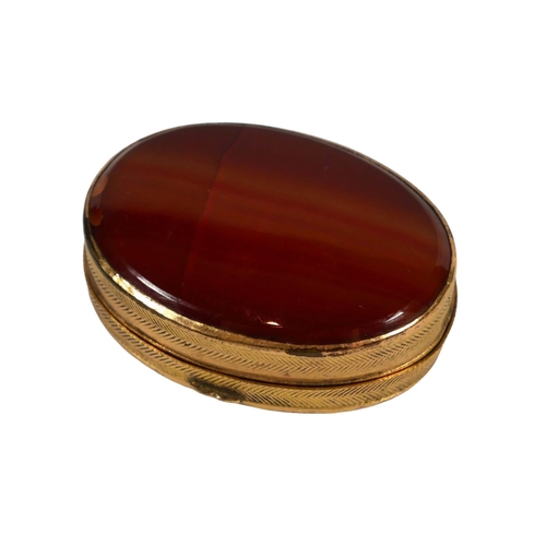 11B - A VICTORIAN YELLOW METAL CARNELIAN AGATE OVAL BOX, YELLOW METAL TESTED AS 18CT YELLOW GOLD. 
(gross ... 