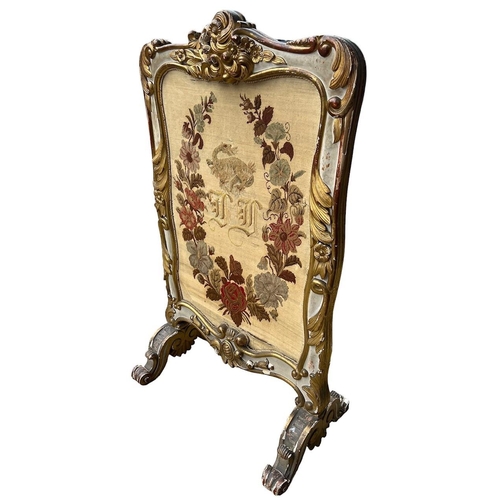 164A - MANNER OF MOREL AND SEDDON, A 19TH CENTURY CARVED GILTWOOD PAINTED FIRE SCREEN 
Decorated with scrol... 