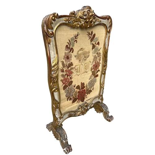 164A - MANNER OF MOREL AND SEDDON, A 19TH CENTURY CARVED GILTWOOD PAINTED FIRE SCREEN 
Decorated with scrol... 