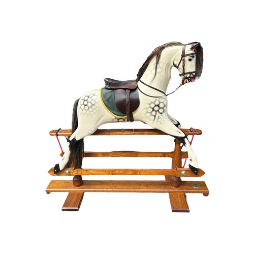 68 - ROCKING HORSE SHOP, A LARGE DECORATIVE CARVED WOOD DAPPLED ROCKING HORSE, with glass eyes leather sa... 