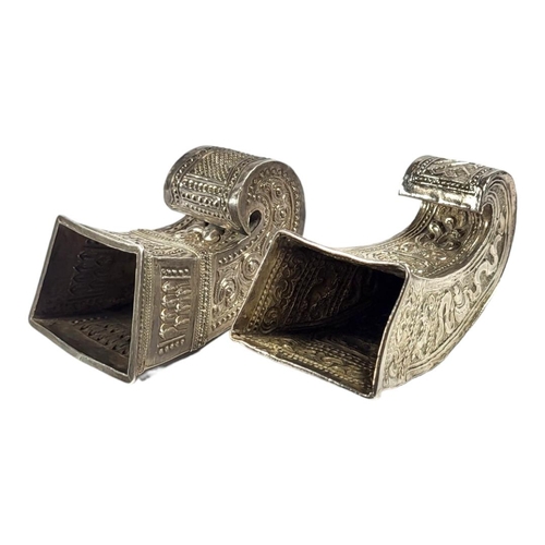 111 - TWO LATE 19TH/EARLY 20TH CENTURY BURMESE SILVER BETEL LEAF HOLDERS
Both having intricate chased and ... 