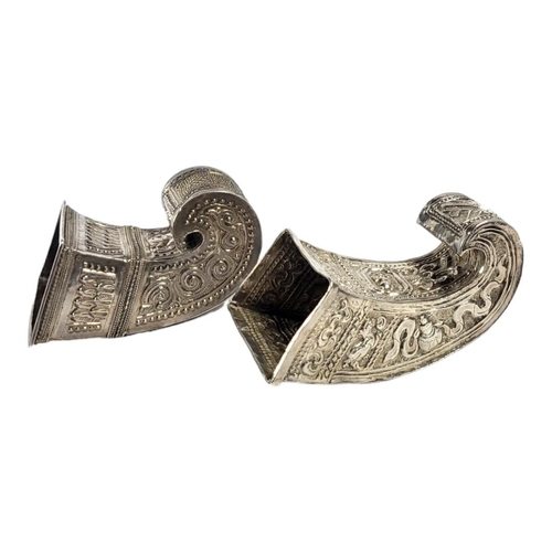 111 - TWO LATE 19TH/EARLY 20TH CENTURY BURMESE SILVER BETEL LEAF HOLDERS
Both having intricate chased and ... 