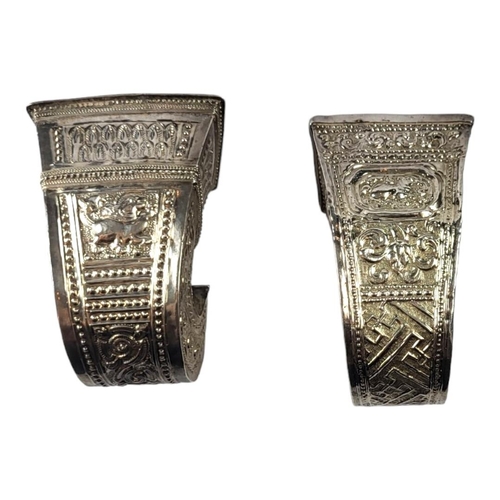 111 - TWO LATE 19TH/EARLY 20TH CENTURY BURMESE SILVER BETEL LEAF HOLDERS
Both having intricate chased and ... 