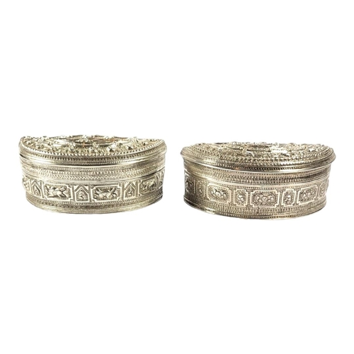 114 - TWO LATE 19TH/EARLY 20TH CENTURY BURMESE SILVER LIME BOX OF DEMILUNE FORM
First having alternating c... 