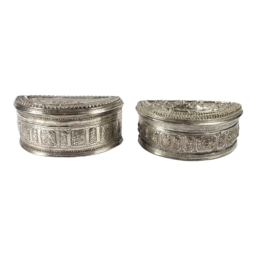 115 - TWO LATE 19TH/EARLY 20TH CENTURY BURMESE SILVER LIME BOX
Demilune form, both having chased stylised ... 