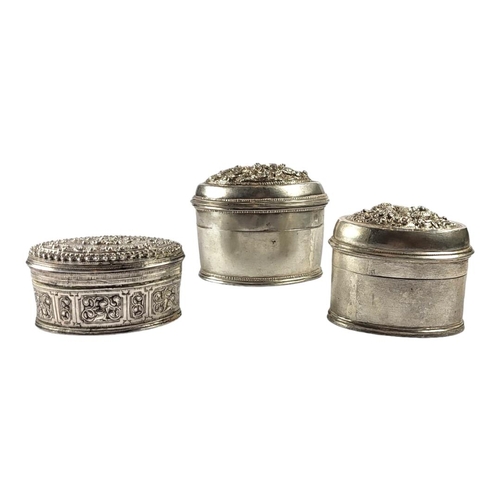 116 - THREE LATE 19TH/EARLY 20TH CENTURY OVAL BURMESE SILVER BETEL LIME BOXES
Having two having chased Chi... 