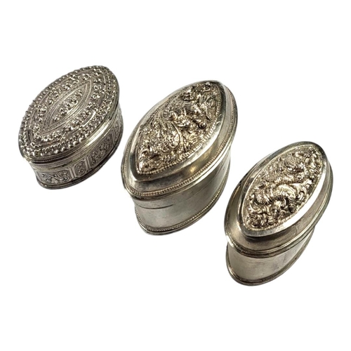 116 - THREE LATE 19TH/EARLY 20TH CENTURY OVAL BURMESE SILVER BETEL LIME BOXES
Having two having chased Chi... 