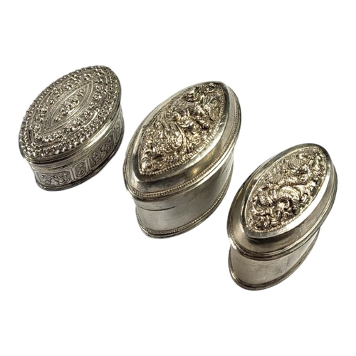 116 - THREE LATE 19TH/EARLY 20TH CENTURY OVAL BURMESE SILVER BETEL LIME BOXES
Having two having chased Chi... 