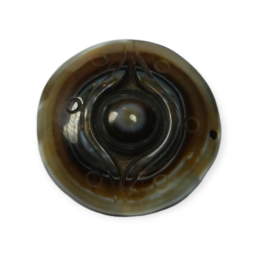 134 - TIBETAN CARVED AGATE BUDDHIST HEAVEN EYE PENDANT.

Provenance: private collection of a gentleman